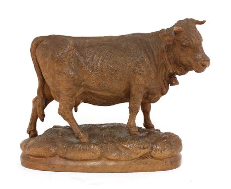 A Black Forest carved wooden model of a cow,c.1900, Swiss, wearing a bell and standing on a naturalistically-carved base,23cm