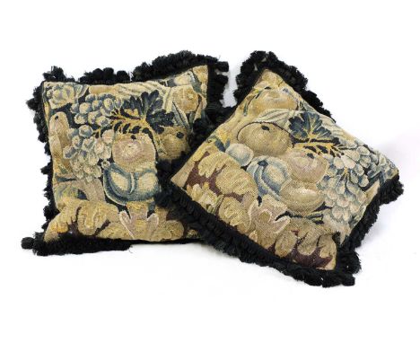 A pair of verdure tapestry cushions,19th century, incorporating fragments from a 17th/18th century French or Flemish wall han