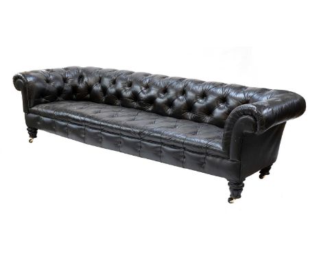 A large buttoned leather chesterfield sofa,19th century, raised on fluted ebonised supports and castors,270cm wide102cm deep6