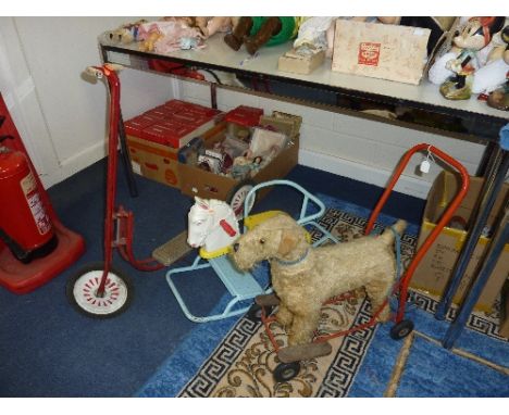 A TRI-ANG PUSH ALONG DOG, some wear to fur, length approximately 58cm, with a Tri-ang horses head rocking chair and a Raleigh