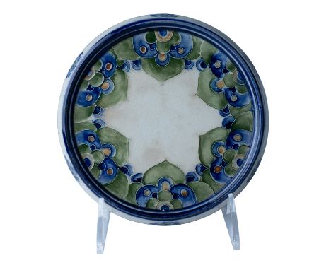An exquisite example of William Moorcroft's early work for James Macintyre &amp; Co., this Florian Ware teapot trivet feature