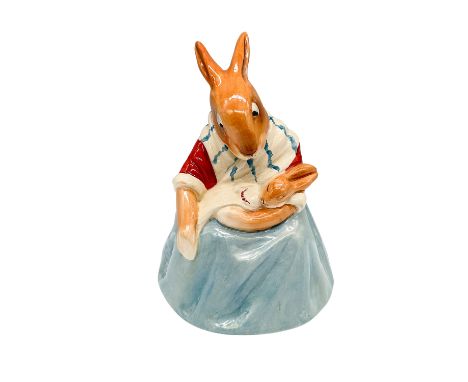 This rare Royal Doulton Bunnykins figurine, titled Mother Bunnykins, features a seated rabbit dressed in a red blouse, white 