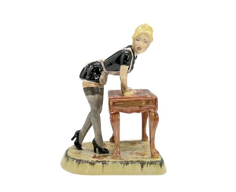 Hand painted glazed figure of a saucy lady in a classic French maid outfit cleaning a table, possibly preparing for role play