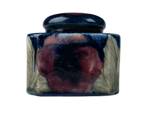A Moorcroft ceramic inkwell featuring the classic Pansy pattern. This square-shaped piece is adorned with vibrant hand painte