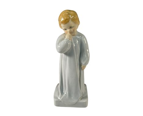 This Royal Doulton figurine was designed by renowned artist Charles Vyse. This charming piece depicts a young child in a whit