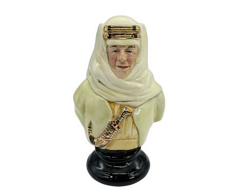 Striking bust of Thomas Edward Lawrence in an off-white keffiyeh, pale yellow shirt and gold accents on headdress and on dagg