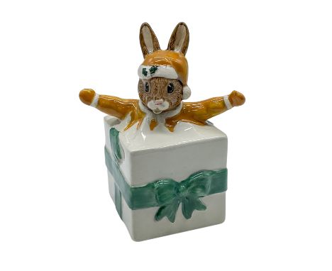 Christmas Surprise RDB146, hand modelled and hand painted figure of a Bunnykin popping out of a present. Goldenrod-yellow, gr