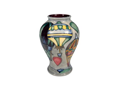 This striking Moorcroft vase features a vibrant hot air balloon design, with bold colors and dynamic patterns that capture th
