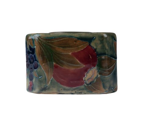 A charming pottery inkwell in the iconic Pomegranate pattern. This piece features vibrant pomegranates and clusters of grapes