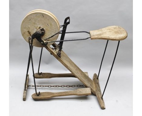 A VINTAGE METAL FRAMED MANUAL PEDAL ACTION GRINDSTONE WITH INTEGRAL SEAT (GWO) 86cm at the highest point 