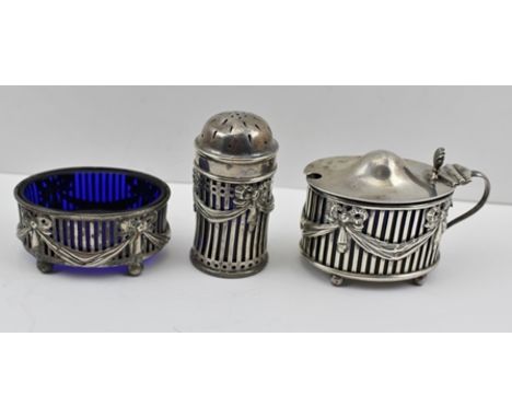 WILLIAM HUTTON AND SONS LTD. A REGENCY DESIGN THREE PIECE SILVER CONDIMENT SET comprising; mustard pot, salt and pepper pot, 