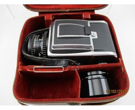 A HASSELBLAD 500 C/M CAMERA with a Carl Zeiss Planar 1:2, 8 f = 80mm lens No.6196714, in leather case, together with an attac