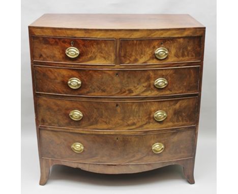 A 19TH CENTURY MAHOGANY BOW FRONTED CHEST of two short over three long drawers, fitted brass oval back-plate handles, raised 