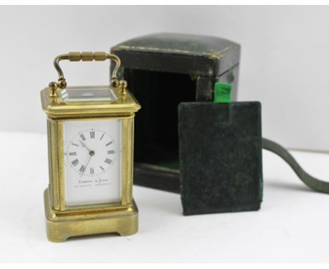 A LATE VICTORIAN MINIATURE CARRIAGE CLOCK, brass frame with bevelled glass, white enamel dial with Roman numerals, inscribed 