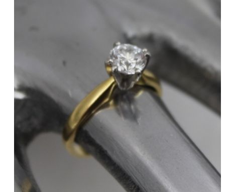 A DIAMOND SOLITAIRE RING with brilliant cut stone and 18ct gold band, size "M and half" 