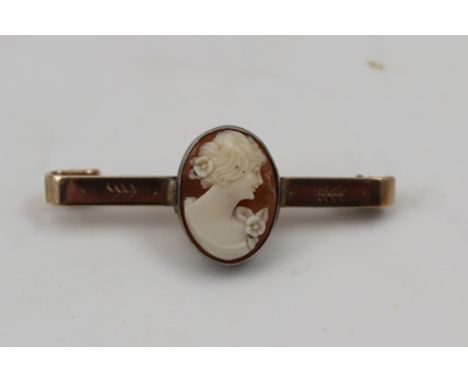 A 9CT GOLD BAR BROOCH mounted with an oval carved shell cameo, profile portrait of a young woman, cameo 1.5cm x 1cm 