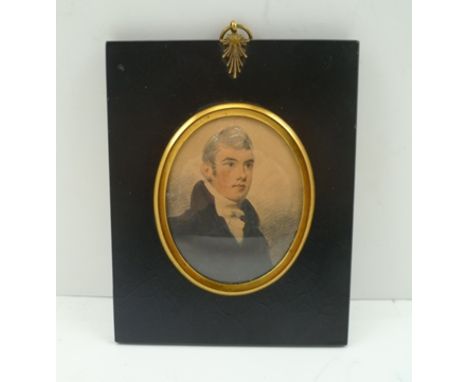 A 19TH CENTURY MINIATURE PORTRAIT PAINTING, bust length of a gentleman wearing a white cravat, in ebonised frame with decorat