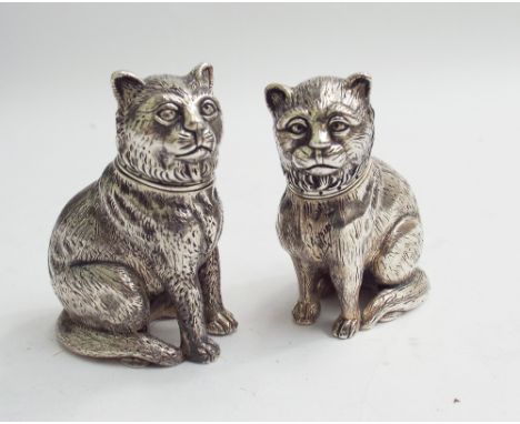 Pair of sterling silver novelty salt and pepper pots, modelled as seated cats, 6 cms high