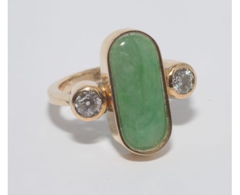 Large and impressive jade and diamond set ring with a large oval panel of jade flanked each side by 2 diamonds in rub over se