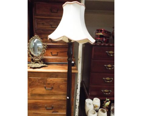 Turned mahogany standard lamp with small cream shade 