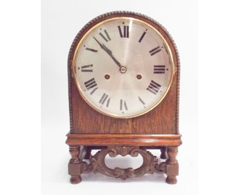 1930's oak arched case mantel clock with striking movement on carved wooden stand 