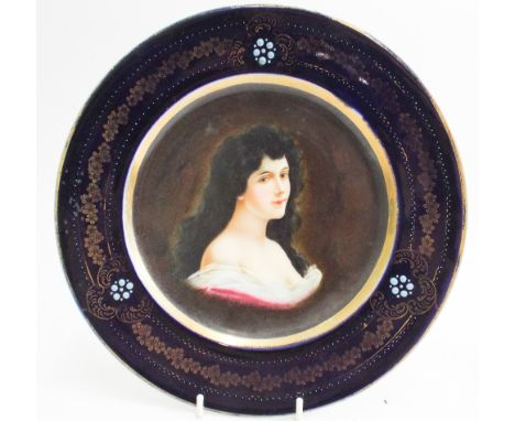 Vienna porcelain cabinet plate decorated with a portrait of lady in low cut dress, blue gilt jeweled border and beehive mark 