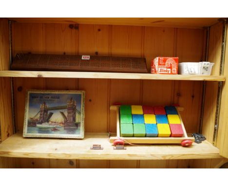 Pastimes:&nbsp;a Victory wood jigsaw puzzle of Tower Bridge, boxed; together with a 1950/60s Slinky, boxed; a set of bone and