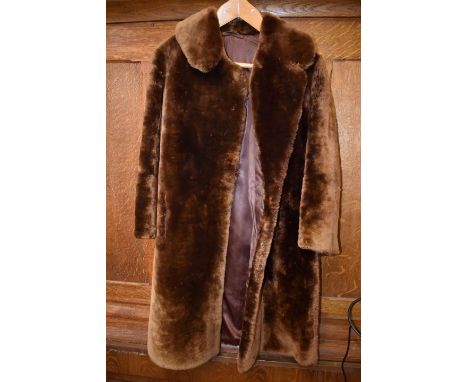 A three quarter length brown fur coat. 
