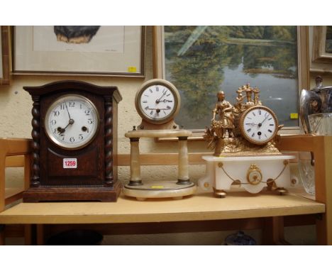 An alabaster portico timepiece; together with another alabaster and metal timepiecel; and a 1920s oak mantel clock. 