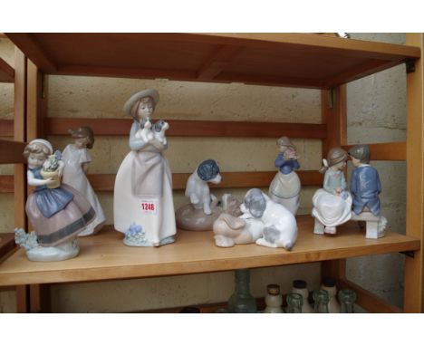 Six Nao figures; together with a Lladro figure.&nbsp; 