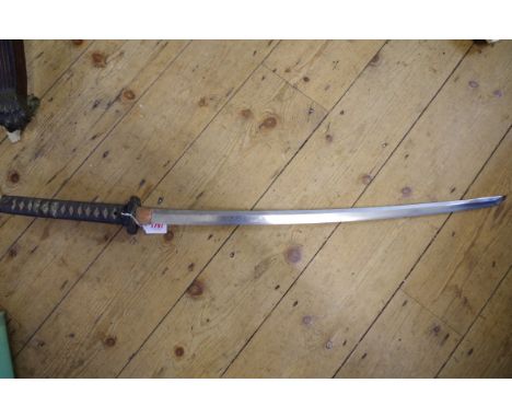 A good antique Japanese katana and leather covered lacquer scabbard. 