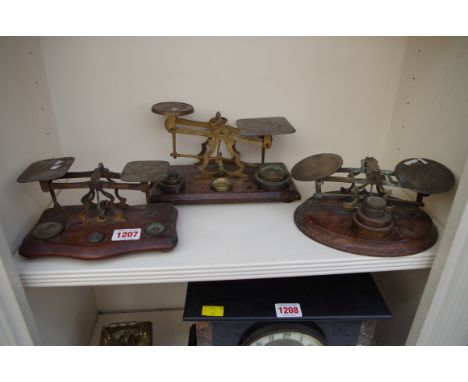Three sets of postage scales, with weights. 