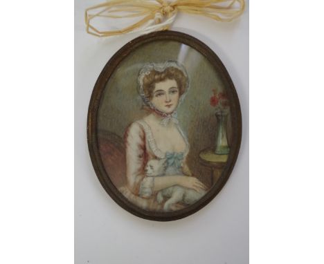 English School, early 19th century, half length portrait miniature of a lady with a dog, 7 x 5.5cm oval.&nbsp; 