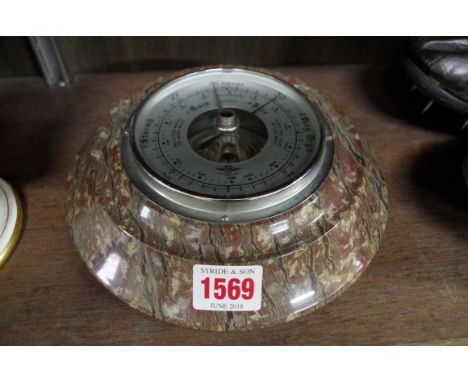 A serpentine framed aneroid barometer,&nbsp;19cm wide.&nbsp; 