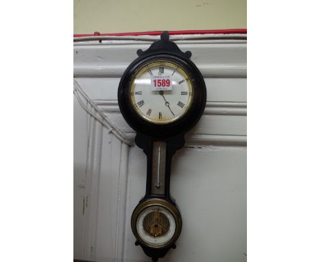 A late 19th century ebonized combined barometer, thermometer and timepiece,&nbsp;36cm high. 