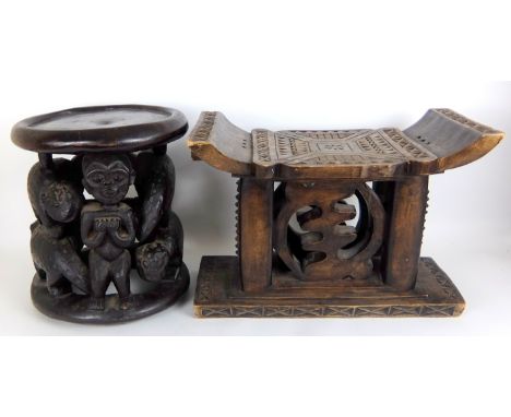 An African Bamileke carved wood stool with a central figure and leopards, 39cm high together with an Ashanti carved wood stoo