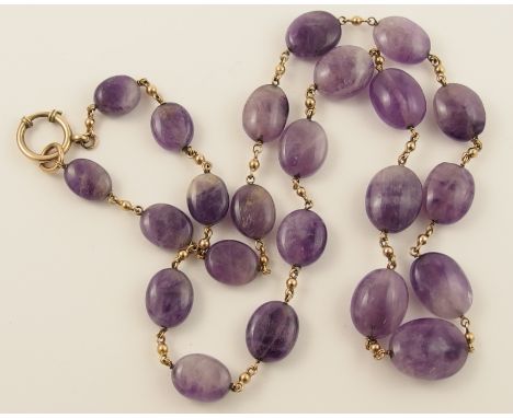 An amethyst bead necklace interspaced with yellow metal beads, indistinctly hallmarked to the clasp. Length approx 66.5cm.