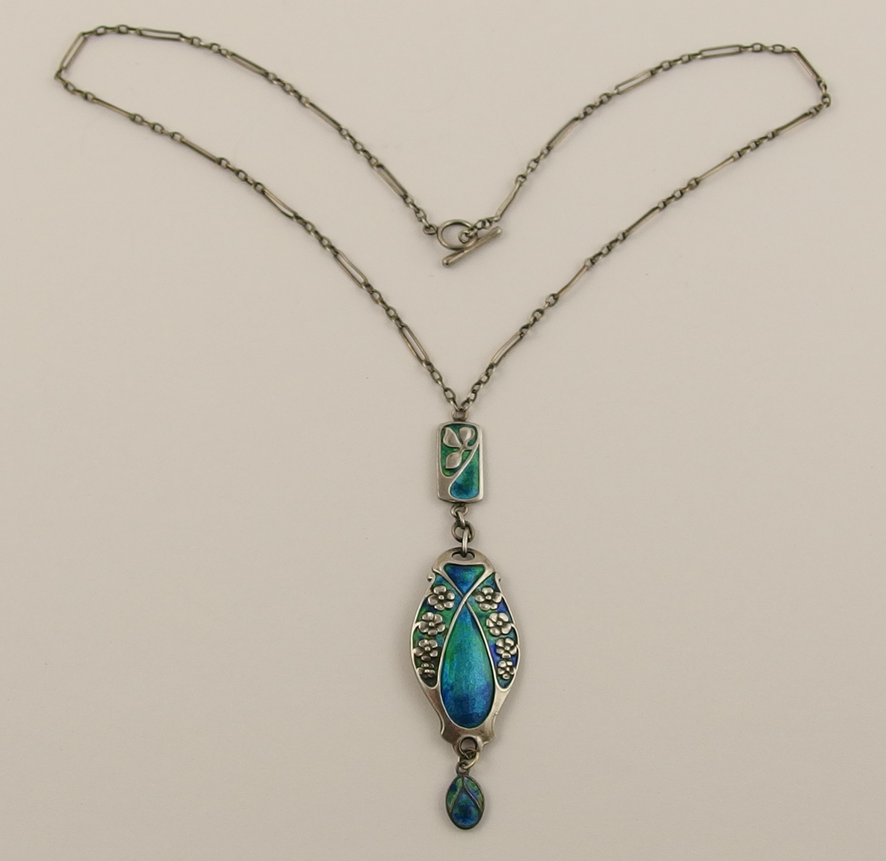 A Merle Bennett enamelled pendant of elongated three parts each one ...