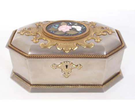 A Victorian white metal jewellery casket circa 1870 of elongated octagonal shape, the hinged lid with applied gilt metal  car