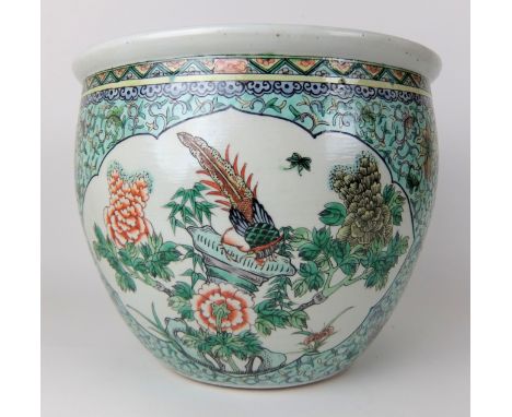 A Chinese famille verte jardiniere painted with panels of flowers divided by scrolling foliage on a light green ground (crack