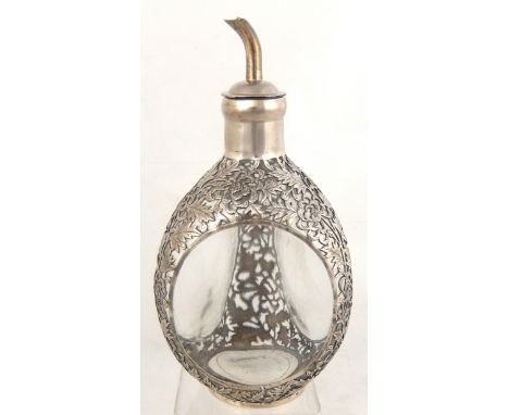 A Chinese overlaid decanter of dimple haig shape, the overlay with pierced foliate decoration, character mark to the plinth b