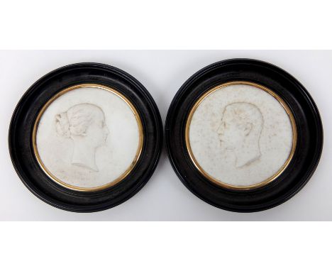 A Sevres biscuit porcelain profile portrait of Eugenie Empress of France in a circular ebonised frame circa 1864, signed J Pe