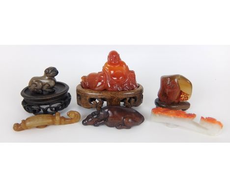 A Chinese agate carved figure of a Buddha 5.5cm high, wood stand, carving of two figures silhouetted against a rock, 4cm high