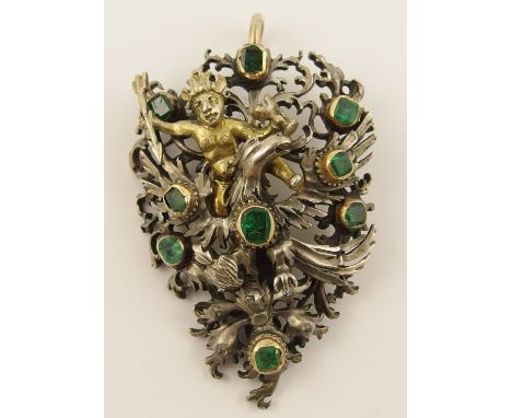 An Austro Hungarian style pendant  in white metal depicting an eagle clutching a flaming heart in its claws, riding on his ba