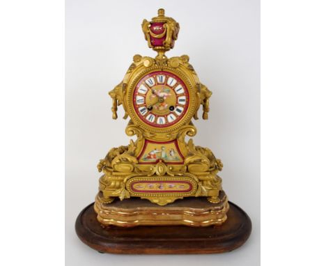 A Victorian ormolu mantle clock the painted dial and movement named to J Muirhead & Sons, Glasgow and Paris with a central pu