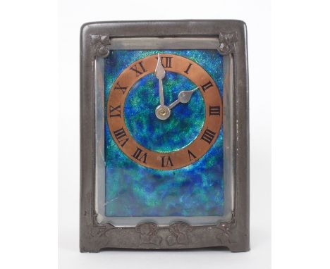 A Liberty & Co pewter and enamel carriage clock in the manner of Archibald Knox, cast with vine, the enamel blue green face w