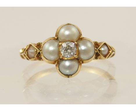 An Edwardian pearl and diamond ring set in unhallmarked yellow metal, the quatrefoil shape had an old cut diamond to the cent