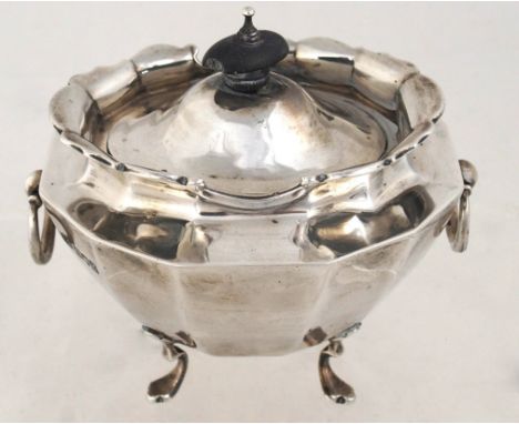 An Edwardian silver tea caddy by Charles Clement Pilling, London 1902, the faceted oval body with scalloped border, hinged li