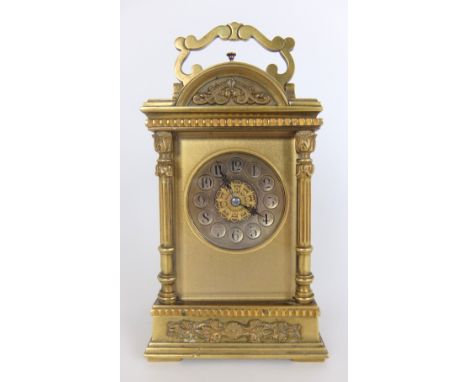 A French brass repeater carriage clock the domed bevelled glass top with scroll branch handle above a silvered circular dial 