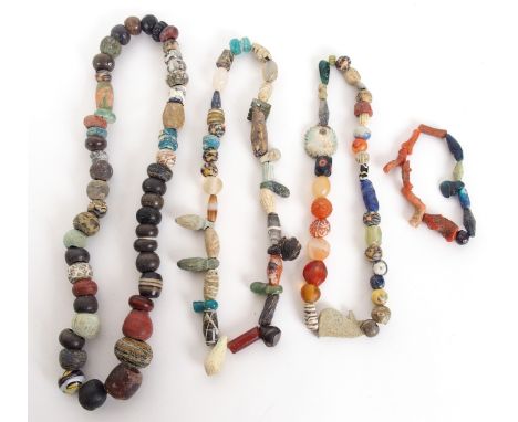 Four Egyptian glass bead, ceramic and coral necklaces 9cm, 17cm, 20cm and 25cm long, 1500BC and later (4)